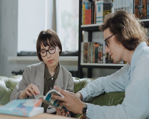 Group of adults discussing literature in a reading club setting